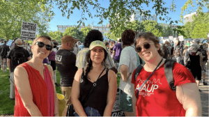 People posing with group in background