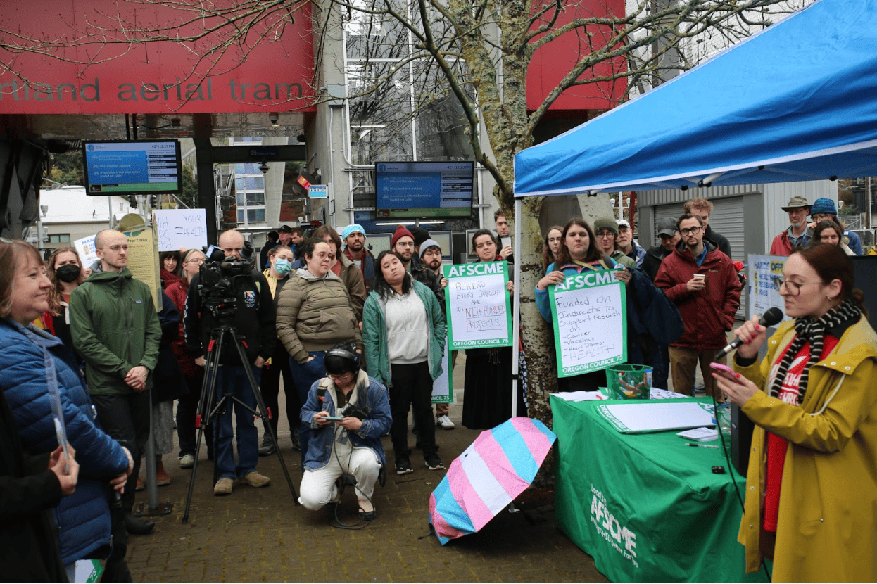 group gathered around a speaker