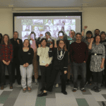 Group of people posing with fists in the air